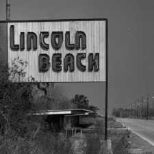 Black and white photograph of a sign that says "Lincoln Beach"